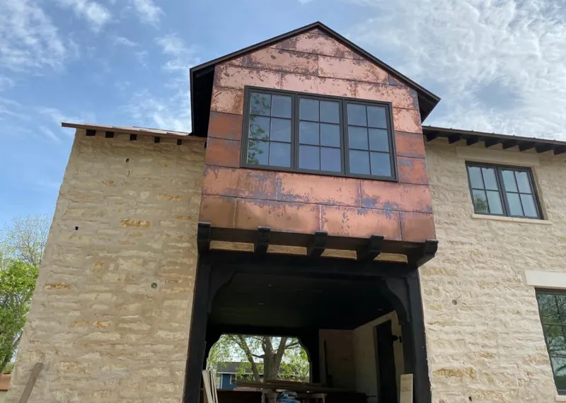 Copper metal panel facade on a stone building for Roof Repair in Niceville