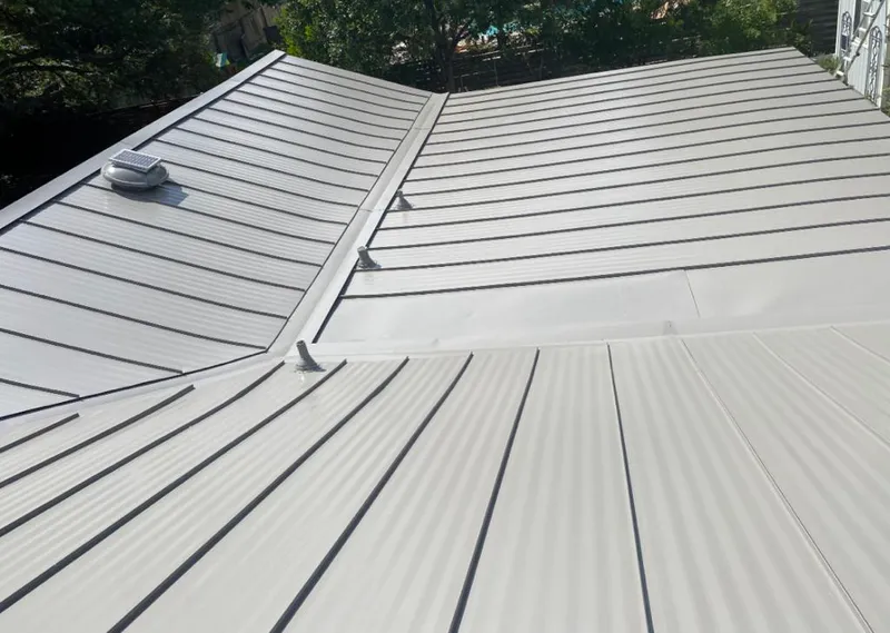 Solar attic fan installed on a metal roof for Roof Ventilation in Niceville